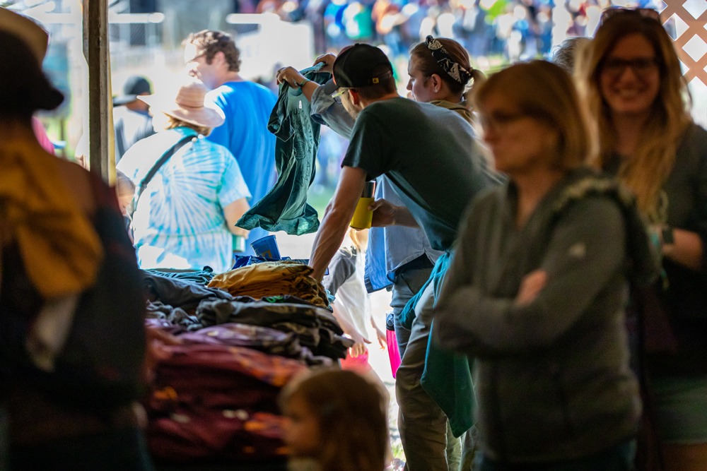 Customers shopping in the merch tent at a musical festival